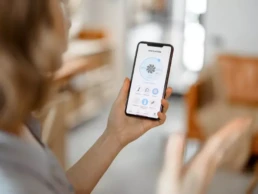 female looking at phone with indoor air quality information